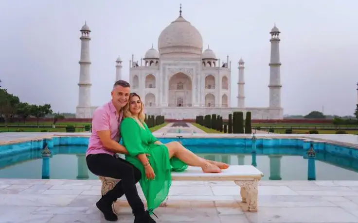 Couple posing in front of the Taj Mahal during Agra Overnight Tour by Namaste Yatra Tours