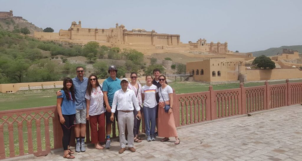 Happy couple enjoying amber fort during the Golden Triangle Tour with varanasi by Namaste Yatra Tours