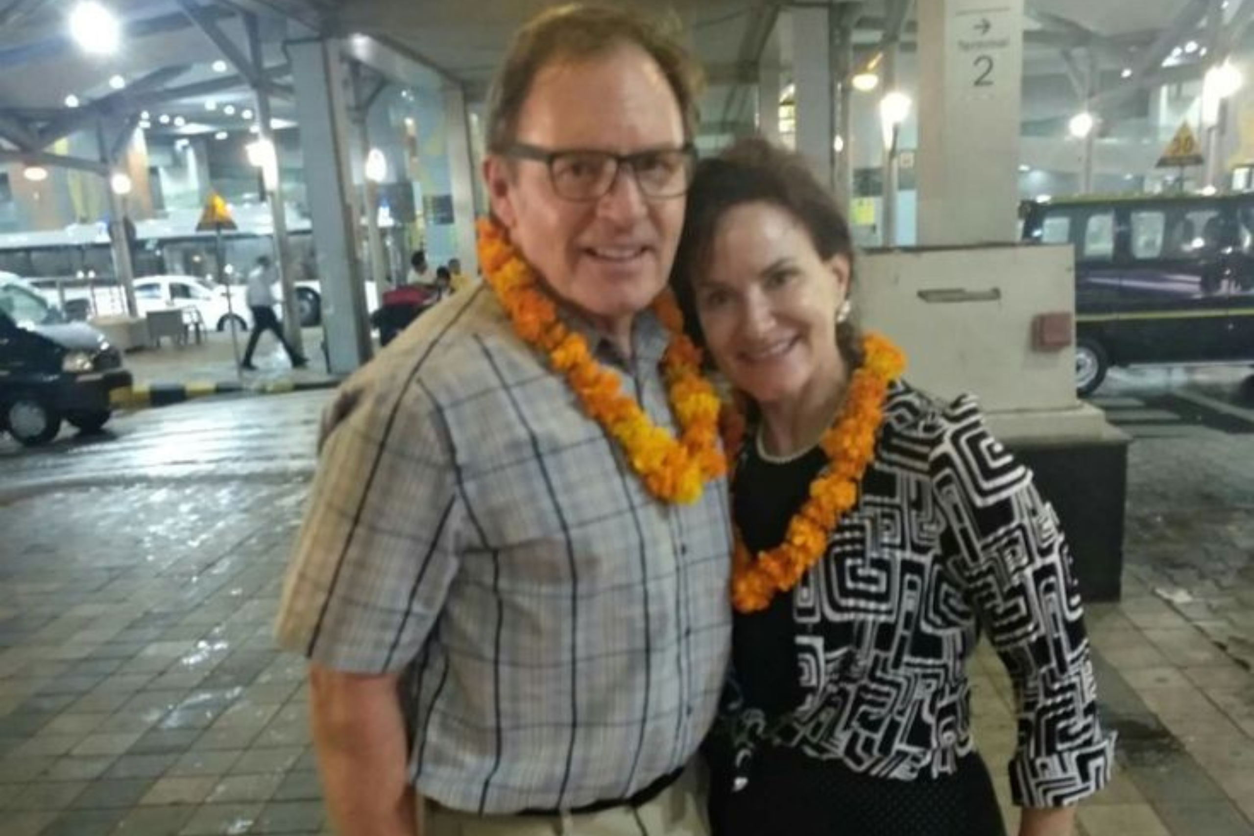 Couple receiving a traditional welcome at Delhi Airport for the Golden Triangle Tour 3 Days with Namaste Yatra Tours
